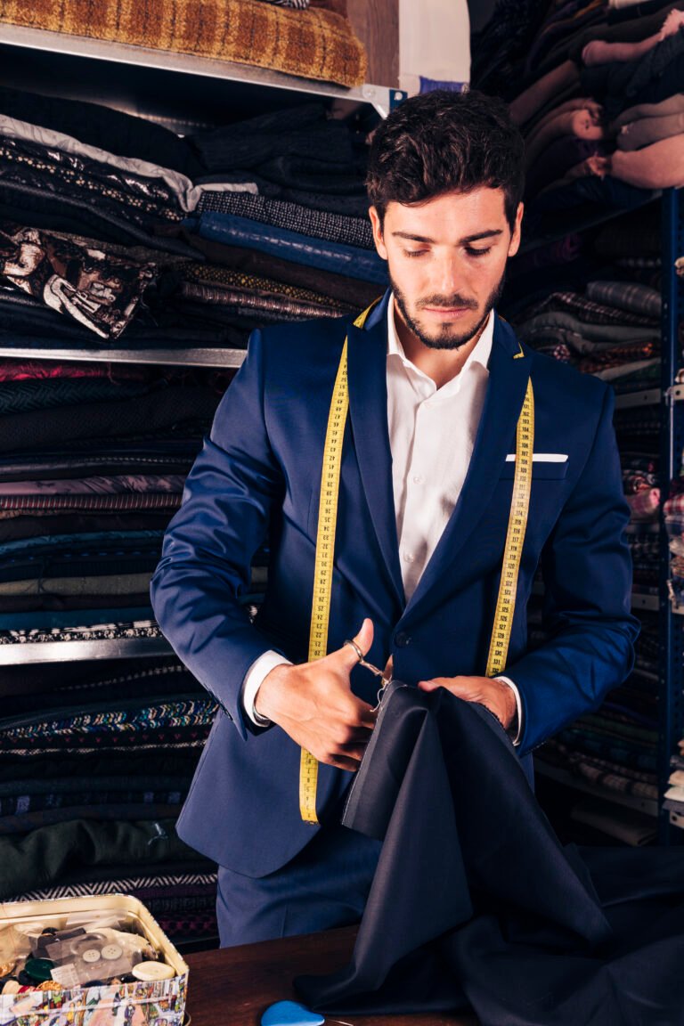 portrait-young-male-tailor-working-his-workshop